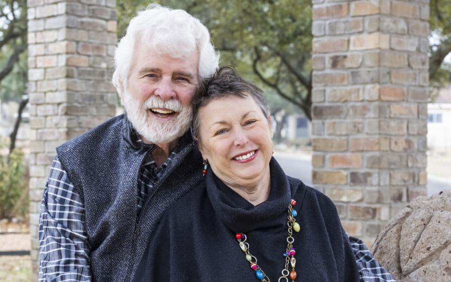 Cody and Kathy Phillips sit next to one another in a brick gazebo.